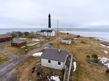 Tower of Sorve lighthouse and buildings on peninsula of Baltic sea. Spring season. Saaremaa, Estonia, Europe Royalty Free Stock Images Tower of Sorve lighthouse and buildings on peninsula of Baltic sea. Spring season. Saaremaa, Estonia, Europe Royalty Free Stock Images