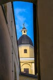 The tower of the St Theresa`s Church with an angel through the arch in the old town of Vilnius, Lithuania royalty free stock photography The tower of the St Theresa`s Church with an angel through the arch in the old town of Vilnius, Lithuania royalty free stock photography