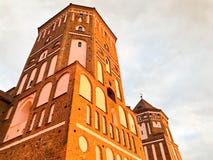Towers and spiers of a high medieval stone old ancient beautiful castle against a blue sky royalty free stock photography Towers and spiers of a high medieval stone old ancient beautiful castle against a blue sky royalty free stock photography