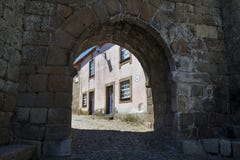 The town`s gate and the facade of a colorful house in the historic village of Castelo Mendo in Portugal stock images The town`s gate and the facade of a colorful house in the historic village of Castelo Mendo in Portugal stock images