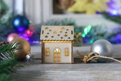 Toy House With Illuminations On The Background Of Christmas Decor Stock Photo Toy House With Illuminations On The Background Of Christmas Decor Stock Photo