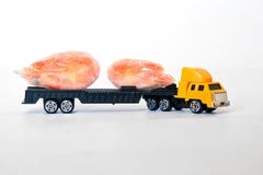 A toy truck carries a pair of frozen shrimps. Seafood delivery. Healthy food