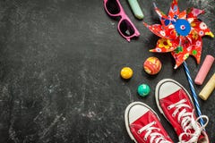 Toys and red sneakers on black chalkboard - childhood Royalty Free Stock Photo Toys and red sneakers on black chalkboard - childhood Royalty Free Stock Photo