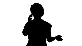 Trabajador de sexo femenino joven de la silueta que habla en el teléfono mientras que camina fotografía de archivo libre de regalías Trabajador de sexo femenino joven de la silueta que habla en el teléfono mientras que camina fotografía de archivo libre de regalías