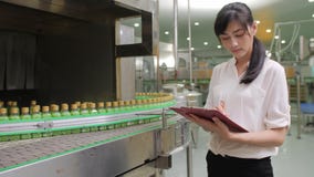 Trabajadores de sexo femenino jovenes en industria fabril de las bebidas que comprueban la calidad del producto almacen de video Trabajadores de sexo femenino jovenes en industria fabril de las bebidas que comprueban la calidad del producto almacen de video