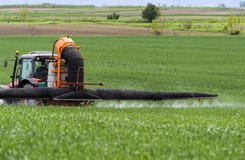 Tractor spraying wheat in field royalty free stock photography Tractor spraying wheat in field royalty free stock photography