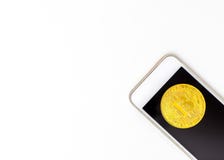 Trading bitcoin on your mobile phone isolated stock photo Trading bitcoin on your mobile phone isolated stock photo