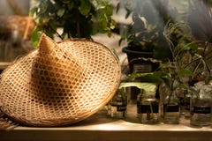 Traditional asian conical bamboo hat on old table with flower in stock photos Traditional asian conical bamboo hat on old table with flower in stock photos