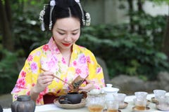 Traditional Asian Japanese Beautiful Woman Conduct Tea Ceremony In Outdoor Garden Royalty Free Stock Image