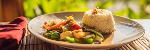 Traditional Balinese cuisine. Vegetable and tofu stir-fry with rice BANNER, long format stock photo Traditional Balinese cuisine. Vegetable and tofu stir-fry with rice BANNER, long format stock photo
