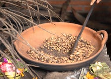 Traditional coffee beans roasting in a pan, hand held spoon moves the beans. Bali tradition. royalty free stock photos Traditional coffee beans roasting in a pan, hand held spoon moves the beans. Bali tradition. royalty free stock photos