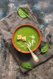 Traditional green cream soup with spinach is served with croutons. Rustic background, top view, flat lay. stock image Traditional green cream soup with spinach is served with croutons. Rustic background, top view, flat lay. stock image