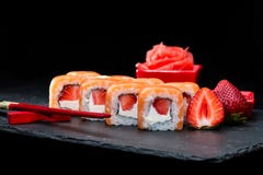 Traditional Japanese Cuisine. Selective Focus On Sweet Sushi Rolls With Salmon, Cream Cheese, Rice And Strawberry On Dark Royalty Free Stock Photo
