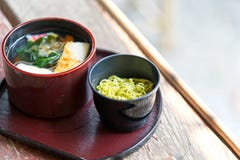 Traditional Japanese food style. Selective focus. Copy space. Bowl of Asian style soup with green tea soba noodles stock images Traditional Japanese food style. Selective focus. Copy space. Bowl of Asian style soup with green tea soba noodles stock images