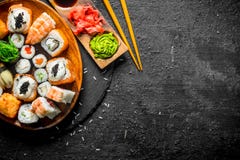 Traditional Japanese rolls and sushi in a plate on a stone Board stock photos Traditional Japanese rolls and sushi in a plate on a stone Board stock photos