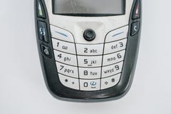 Traditional mobile phone in second generation with keyboard button and mini black and white monitor by white isolate die cut backg stock image Traditional mobile phone in second generation with keyboard button and mini black and white monitor by white isolate die cut backg stock image