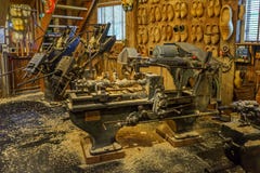 Traditional old clog making machine in workshop with wooden shoes on display royalty free stock images Traditional old clog making machine in workshop with wooden shoes on display royalty free stock images