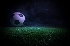 Traditional Soccer Ball On Soccer Field. Close Up View Of Soccer Ball (football) On Green Grass With Dark Toned Foggy Background. Royalty Free Stock Photo