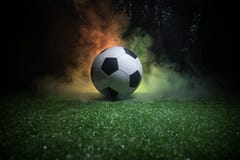 Traditional Soccer Ball On Soccer Field. Close Up View Of Soccer Ball (football) On Green Grass With Dark Toned Foggy Background. Royalty Free Stock Images