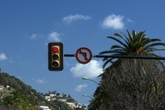 Traffic light against the blue sky. Red color of the traffic light. Turning left is prohibited. stock image Traffic light against the blue sky. Red color of the traffic light. Turning left is prohibited. stock image