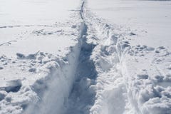 A trail on snowy slope at the top of the mountain royalty free stock photo A trail on snowy slope at the top of the mountain royalty free stock photo