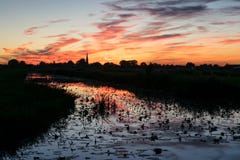 Deep red and orange sky with reflections in the water of a canal near Gouda, The Netherlands royalty free stock photos Deep red and orange sky with reflections in the water of a canal near Gouda, The Netherlands royalty free stock photos