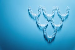 Transparent Straighteners For Teeth In The Shape Of A Pyramid On A Blue Background, Dentistry And Orthodontics. 3D Royalty Free Stock Photo