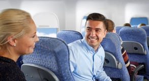 Happy passengers talking in plane stock image Happy passengers talking in plane stock image