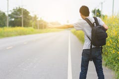 Trave Man With Hat And Backpack Walking On A Road Stock Image