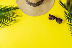 Travel concept: hat, palm leaf and sun glasses on yellow background. Top view, flat lay, space for text stock photos Travel concept: hat, palm leaf and sun glasses on yellow background. Top view, flat lay, space for text stock photos