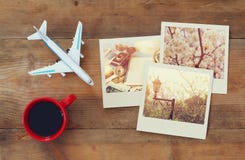Travel instant photographs next to cup of coffee and airplane royalty free stock photos Travel instant photographs next to cup of coffee and airplane royalty free stock photos