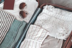 Open traveler`s bag with clothing, accessories and passport, travel and vacations concept .Travel suitcase preparation concept stock photos Open traveler`s bag with clothing, accessories and passport, travel and vacations concept .Travel suitcase preparation concept stock photos