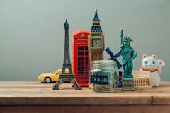 Travel and tourism concept with souvenirs from around the world. Planning summer vacation, money budget trip concept. Saving money