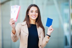 Travel. Woman holding two air ticket in abroad passport near airport stock image Travel. Woman holding two air ticket in abroad passport near airport stock image