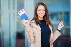 Travel. Woman holding two air ticket in abroad passport near airport royalty free stock image Travel. Woman holding two air ticket in abroad passport near airport royalty free stock image