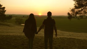 Travelers Man and woman raise their hands and enjoy the sunset. Teamwork travelers with backpacks. Happy family of stock video footage Travelers Man and woman raise their hands and enjoy the sunset. Teamwork travelers with backpacks. Happy family of stock video footage