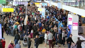 Travelers at Schiphol airport, Amsterdam. Travelers at Schiphol Airport in Amsterdam, Holland on May 25, 2017 Travelers at Schiphol airport, Amsterdam. Travelers at Schiphol Airport in Amsterdam, Holland on May 25, 2017