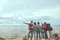 Travelers standing at the seashore looking for the ship stock photography Travelers standing at the seashore looking for the ship stock photography