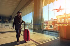 Traveling woman and luggage walking in airport terminal and air royalty free stock image Traveling woman and luggage walking in airport terminal and air royalty free stock image