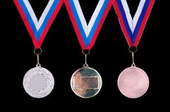 Tre medaglie, oro, argento e bronzi immagine stock Tre medaglie, oro, argento e bronzi immagine stock