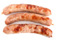 Tre salsiccie fritte di chipolata su un bianco immagini stock Tre salsiccie fritte di chipolata su un bianco immagini stock