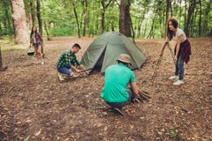 Trekking, camping and wild life concept. Photo of four best friends, setting the camp in the woods near canyon, all are excited stock photo Trekking, camping and wild life concept. Photo of four best friends, setting the camp in the woods near canyon, all are excited stock photo