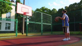 Trenes del jugador de básquet en la calle para anotar la bola en la cesta Juego de entrenamiento del baloncesto Deporte del conce almacen de video Trenes del jugador de básquet en la calle para anotar la bola en la cesta Juego de entrenamiento del baloncesto Deporte del conce almacen de video