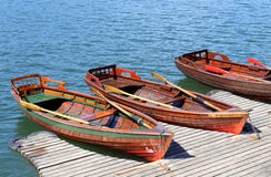 Tres botes de remos amarrados en la orilla del lago Imagen de archivo libre de regalías Tres botes de remos amarrados en la orilla del lago Imagen de archivo libre de regalías