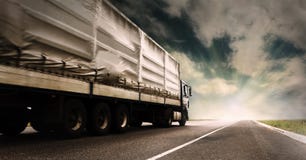 Truck on the highway. Big tented truck on the lonely highway Truck on the highway. Big tented truck on the lonely highway