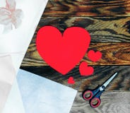 Três corações vermelhos feitos do papel e das tesouras no fundo de madeira escuro velho do grunge Fotografia de Stock Royalty Free Três corações vermelhos feitos do papel e das tesouras no fundo de madeira escuro velho do grunge Fotografia de Stock Royalty Free
