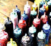 Tubos de color del foco con una pintura en un fondo de la tabla foto de archivo libre de regalías Tubos de color del foco con una pintura en un fondo de la tabla foto de archivo libre de regalías