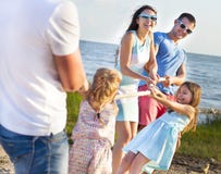 Tug of war - family playing on the beach. Summer holiday stock photography Tug of war - family playing on the beach. Summer holiday stock photography