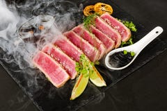 Tuna steak and smoke stock image Tuna steak and smoke stock image