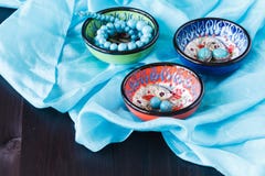 Turquoise earrings on bowl. Fashion background stock photo Turquoise earrings on bowl. Fashion background stock photo